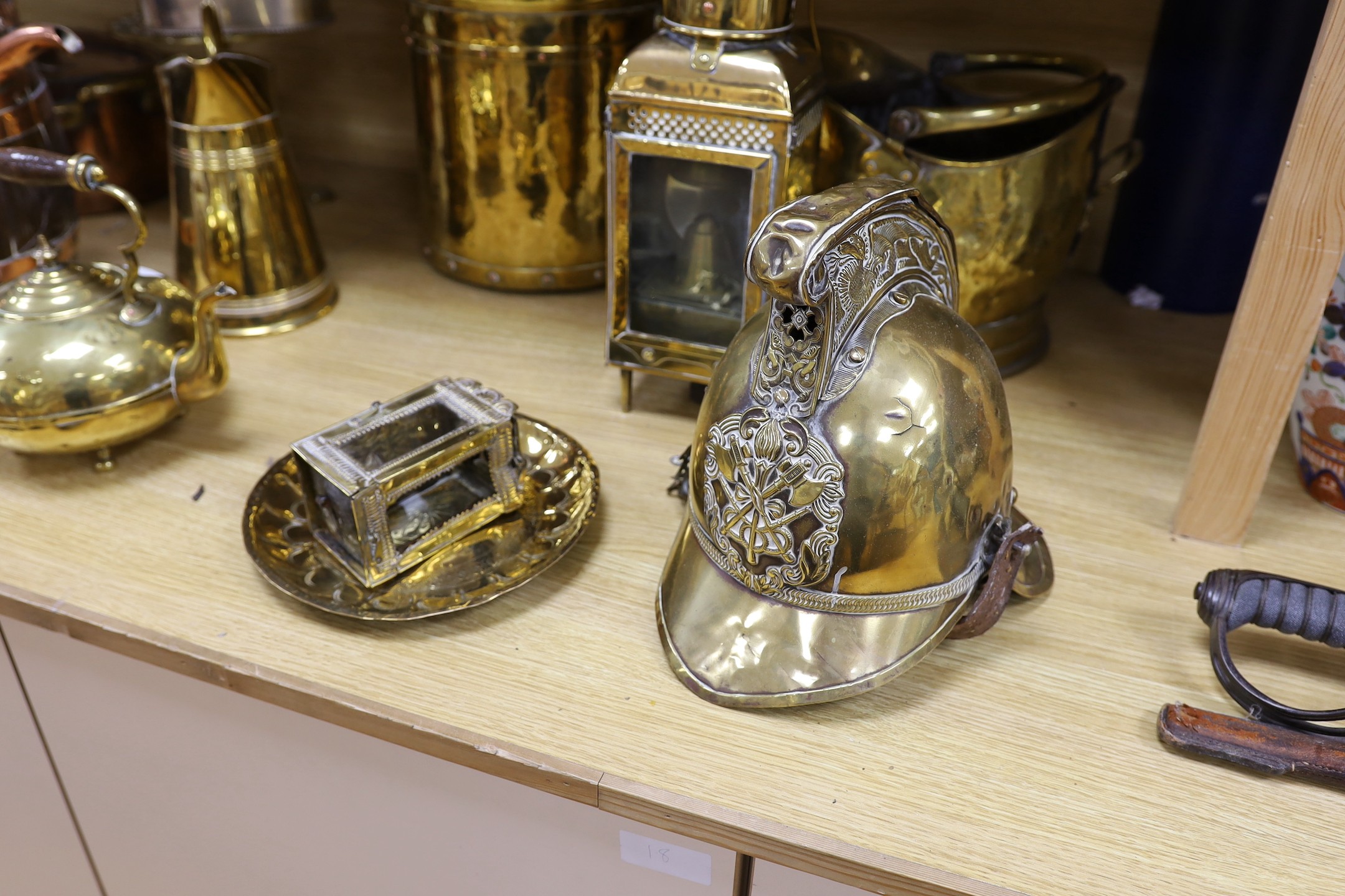 Sundry brass and copper, including a brass fireman’s helmet, a coal helmet, a staved and coopered wood and copper jug, a Victorian brass warming pan, a Victorian copper warming pan, a Victorian brass kettle etc.